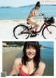 A woman in a red bikini riding a bike on the beach.